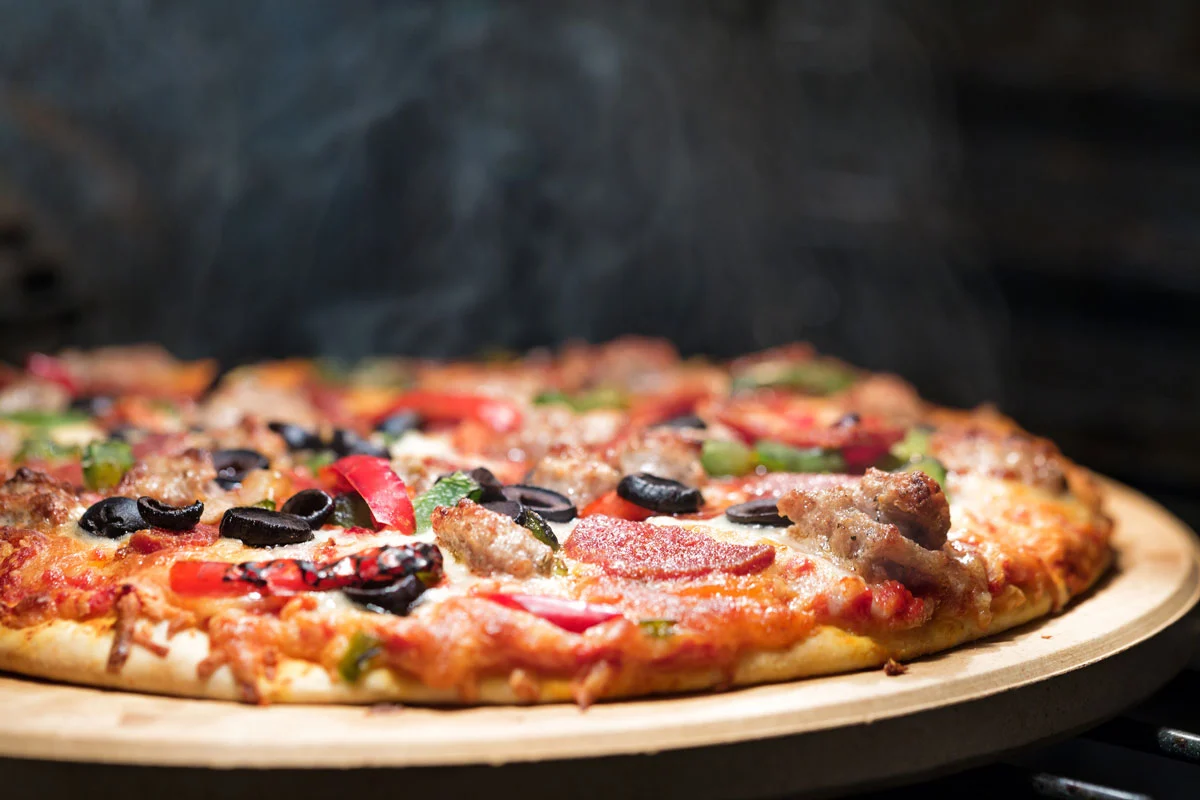 Fresh hand-tossed pizza baking on the stone at DJ's Pizzeria & Lounge, the best pizza restaurant in St. Albert, AB